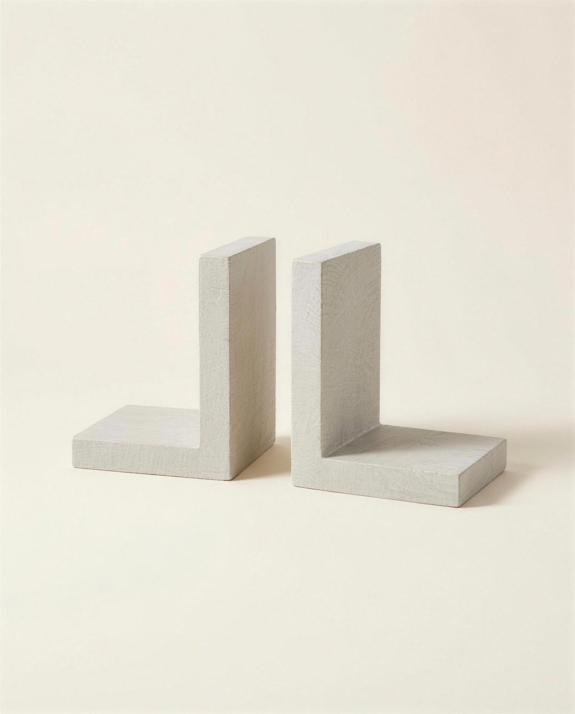 The Corbel Bookends: a matched pair of L-shaped blocks cut from pale grey-cream limestone.