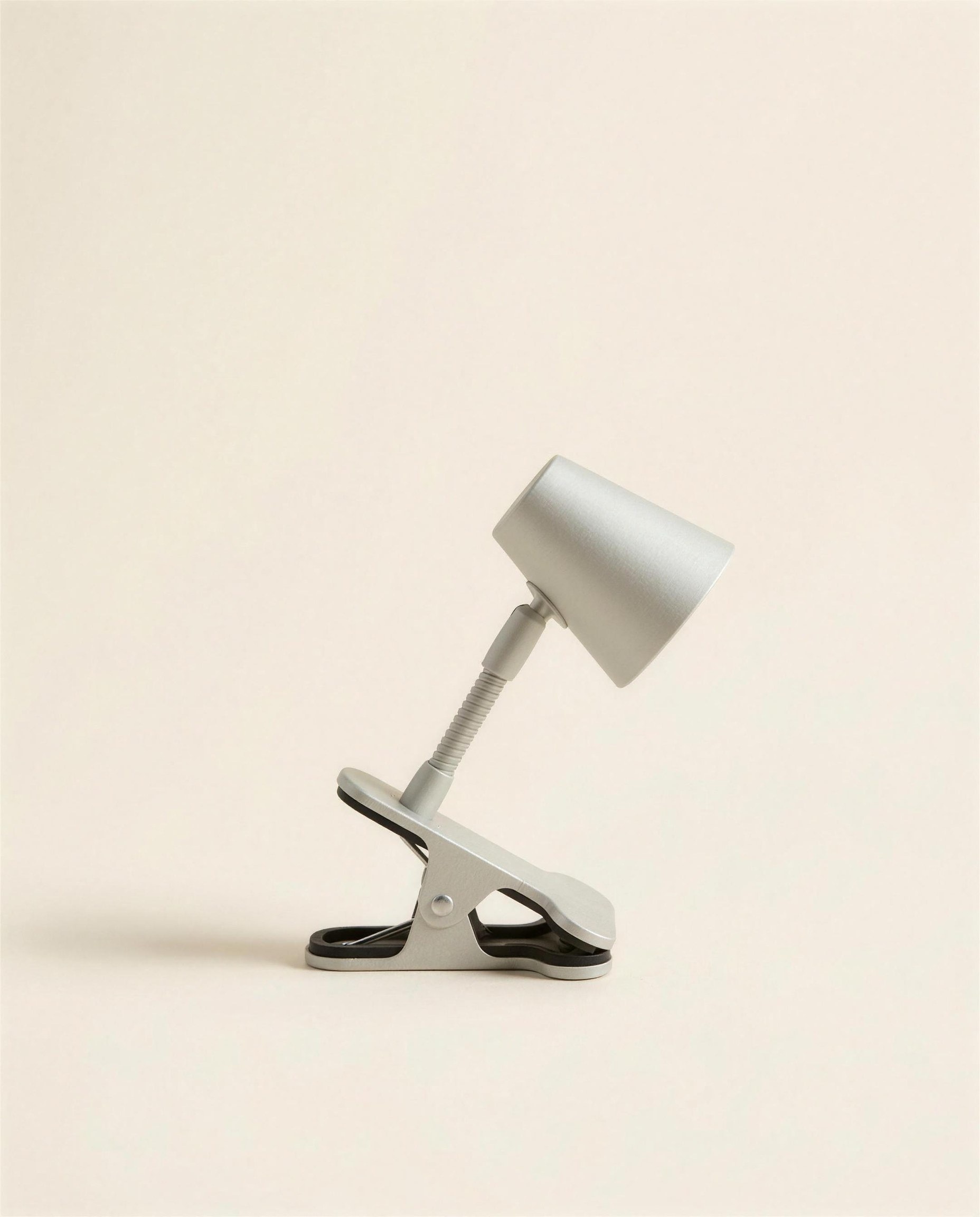 The Nook Clip Light: a small pale grey anodised aluminium task light with a spring clamp and conical shade.